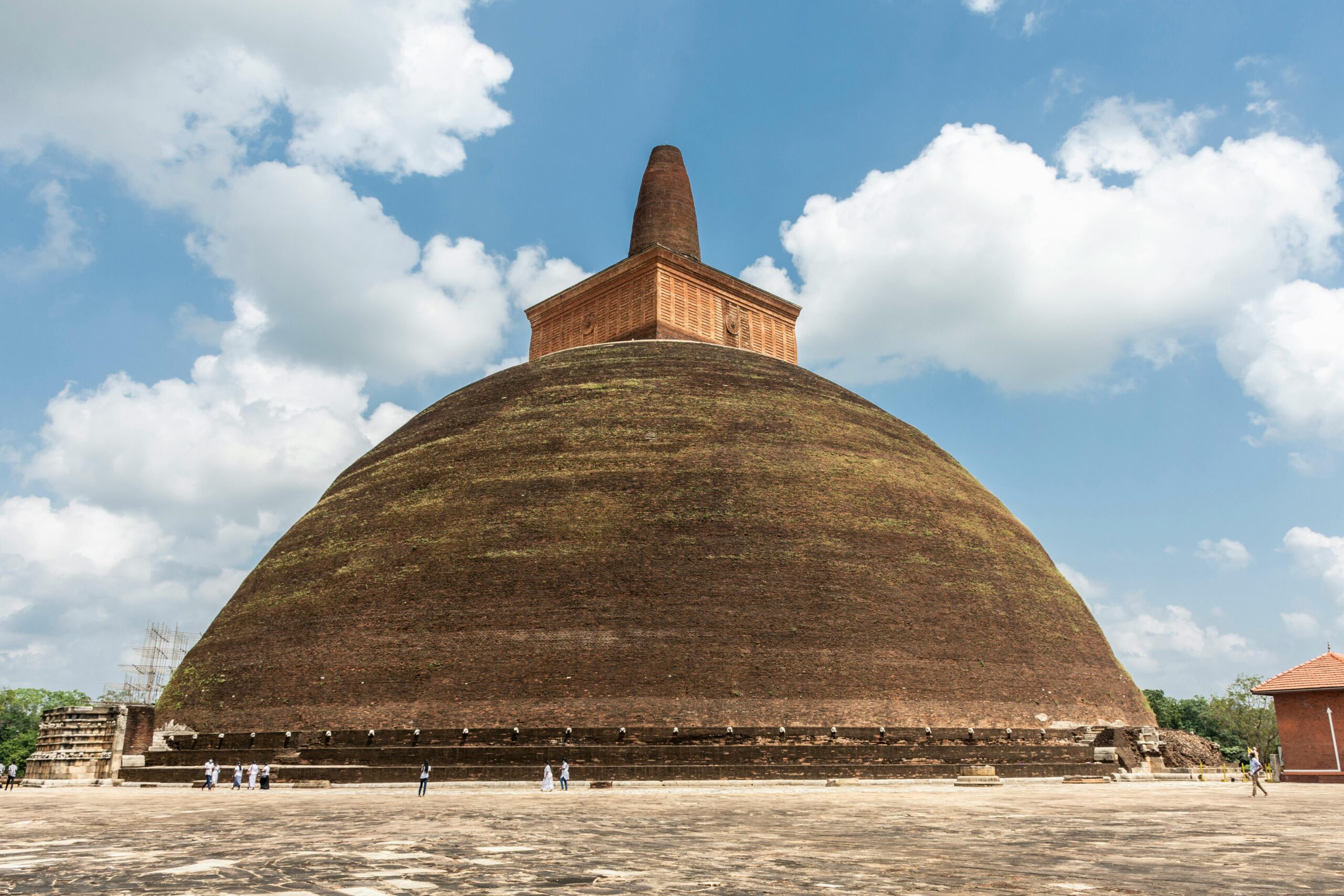Explore the ancient Abhayagiri Stupa in Anuradhapura heritage under a clear blue sky. Rankoth Vehera: The Golden Pinnacle Stupa
